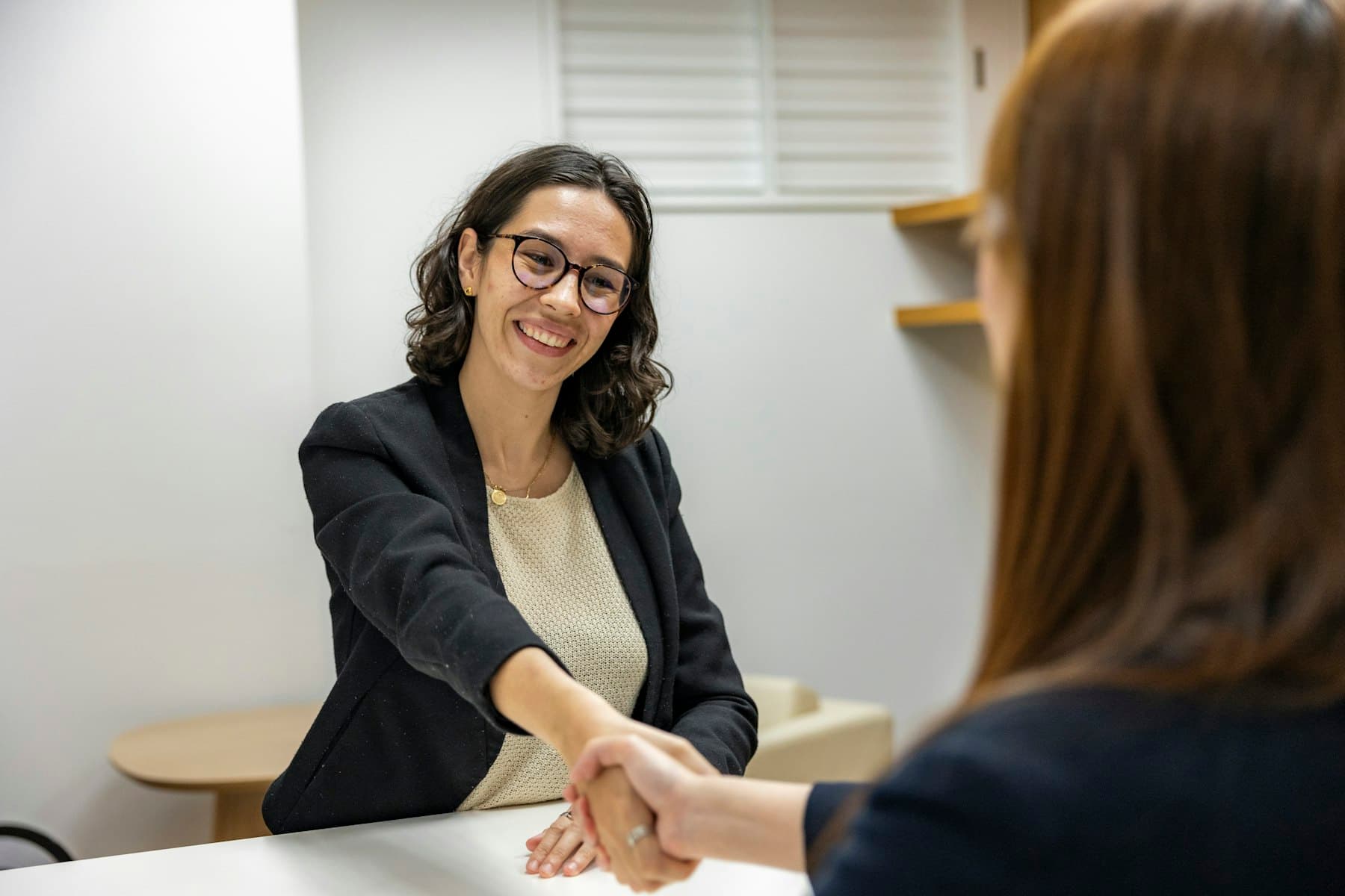 A candidate shaking hands with a hiring manager at the end of a job interview